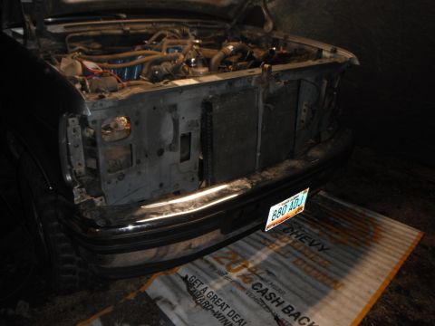 1995 Ford F-150 - Front view of a 1995 Ford F-150 with the hood open, revealing the engine and missing headlight assembly.
