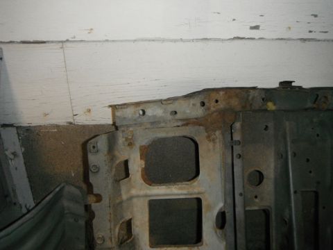 1995 Ford F-150 - This photo shows a section of a rusted vehicle frame, likely from the front end, with several square openings.