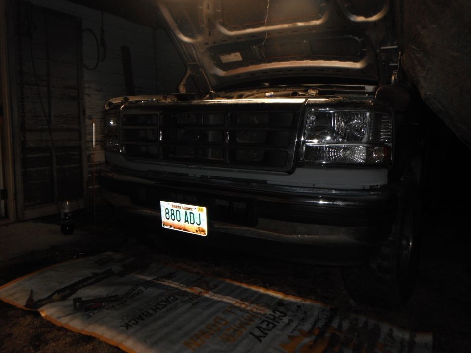 1995 Ford F-150 front with hood open, showing grille and headlights