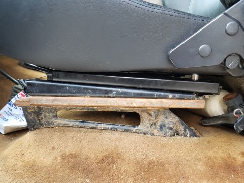 1988 Ford Bronco - A close-up view of a vehicle's interior seat mounting bracket.