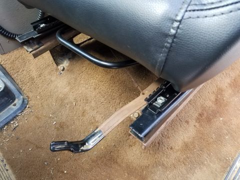 1988 Ford Bronco - The seat adjustment lever is visible on the floor of the vehicle's interior.