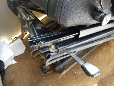 1988 Ford Bronco - Close-up of a seat slider mechanism, showing the metal rails and adjustment lever.