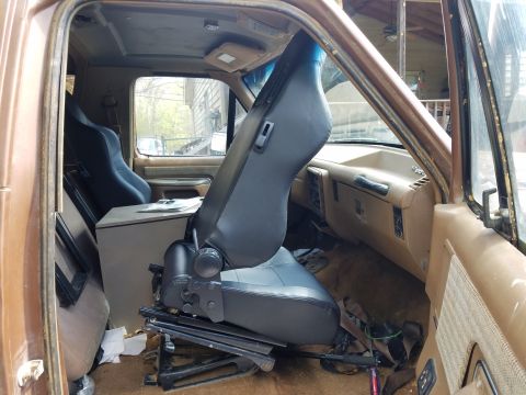 1988 Ford Bronco - Interior view of a 1988 Ford Bronco, racing seats and a modified center console.