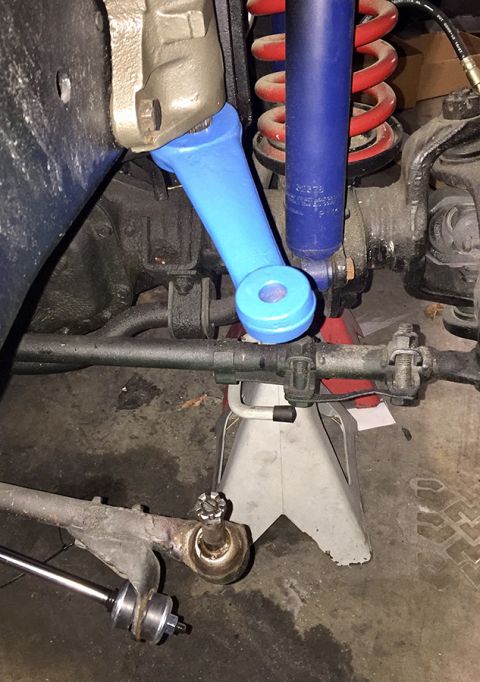 1978 Ford Bronco - Vehicle suspension components, including steering linkage and shock absorber, are shown on jack stands.