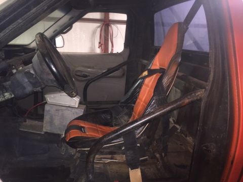 1982 Ford Bronco - Modified interior with racing seat and roll cage, likely for off-road use.