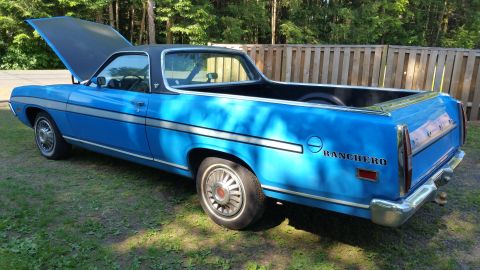 1971 Ford Ranchero - Blue 1971 Ford Ranchero pickup truck with hood open, parked outdoors.