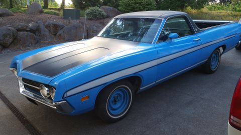 1971 Ford Ranchero - A blue 1970 Ford Ranchero pickup truck with racing stripes is parked on asphalt.