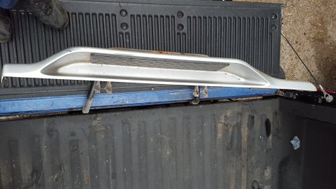 1994 Ford Bronco - A single running board is shown lying in the bed of a pickup truck.