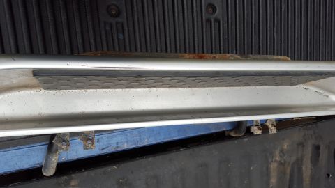 1994 Ford Bronco - Close-up of a vehicle running board, showing its construction and step pad detail.