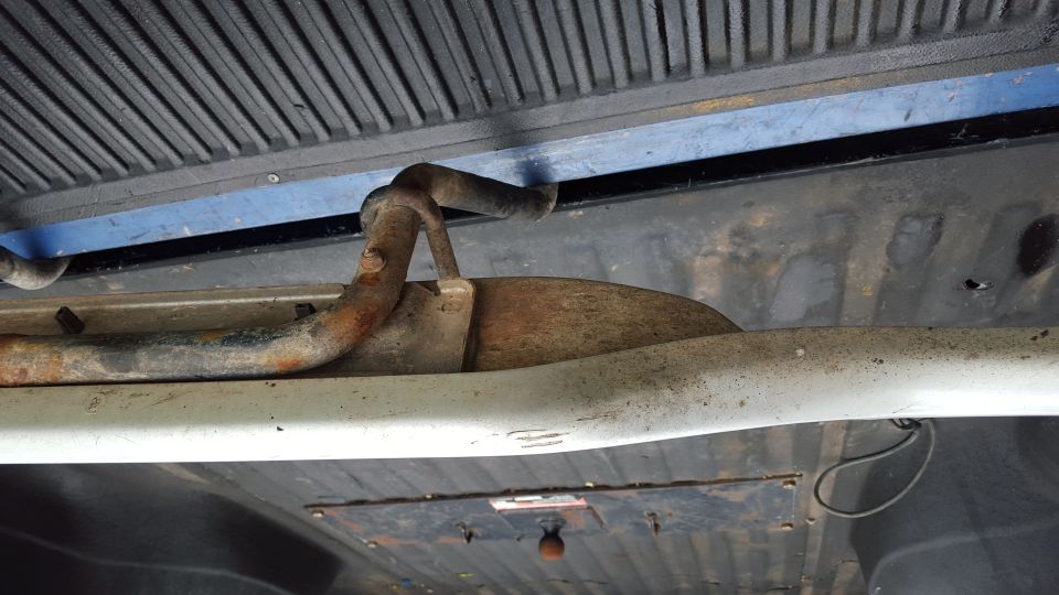 Running board bracket on underside of vehicle