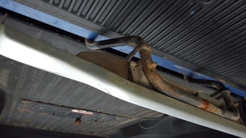 1994 Ford Bronco - Underside view of a vehicle's running board bracket and associated hardware.