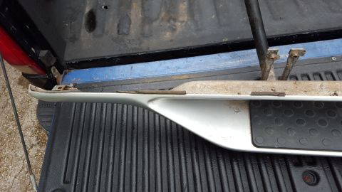 1994 Ford Bronco - A white running board with a black step pad is shown, likely removed from a vehicle.