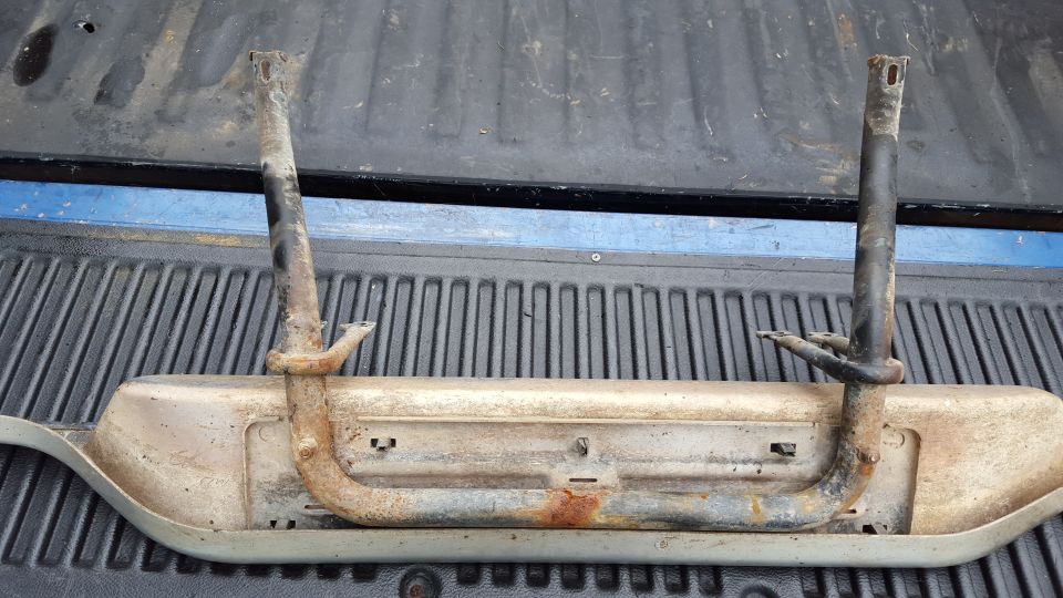 rusted running board bracket with two upright posts