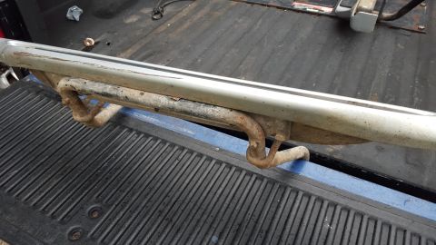 1994 Ford Bronco - A close-up view of a vehicle's running board, showing its metal construction and mounting brackets.