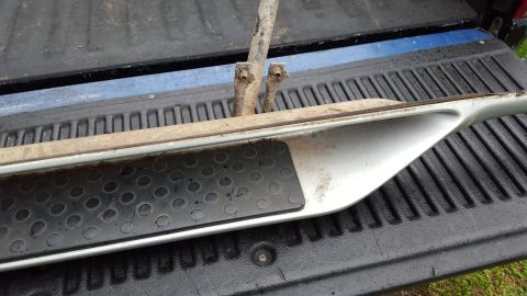 1994 Ford Bronco - A single running board is shown, removed from a vehicle and placed in a truck bed.