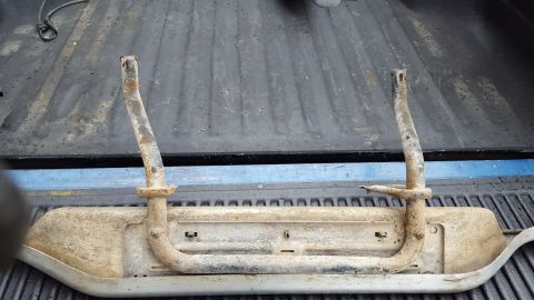 1994 Ford Bronco - Rusty running boards are shown laid out in the bed of a pickup truck.