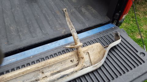 1994 Ford Bronco - A single, weathered running board bracket is shown in the bed of a pickup truck.