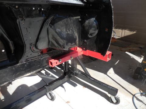 1966 Ford Fairlane - The black car frame is supported by a red engine stand, with the Supermotors.net logo visible at the bottom right.