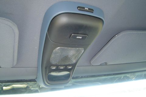 1993 Ford Bronco - Interior shot of a vehicle's overhead console, a garage door opener and interior light.