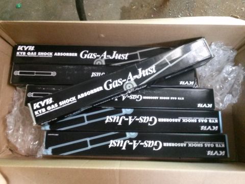 1996 Ford Bronco - Several KYB Gas-A-Just shock absorber boxes are stacked inside a cardboard box.