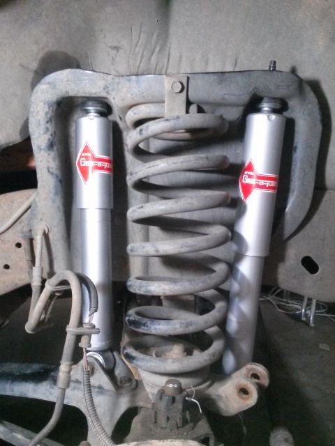 1996 Ford Bronco - Close-up view of the suspension system, showing KYB Gas-a-just shock absorbers and coil springs.