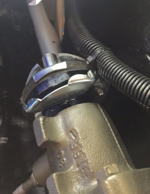 1978 Ford Bronco - Close-up view of a vehicle's steering column linkage and a brake master cylinder casting, showing some stamped numbers.