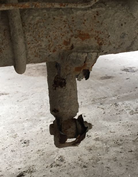1996 Ford F-150 - This heavily corroded suspension component shows significant wear and tear.