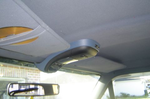1993 Ford Bronco - Vehicle interior showing an overhead console with a CD holder and dome light.