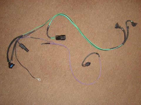 1967 Mercury Cougar - A wiring harness with various connectors and colored wires is laid out on a brown surface.