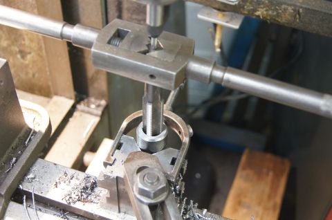 1979 Ford Bronco - Tapping threads into a metal part using a tap wrench and milling machine setup.