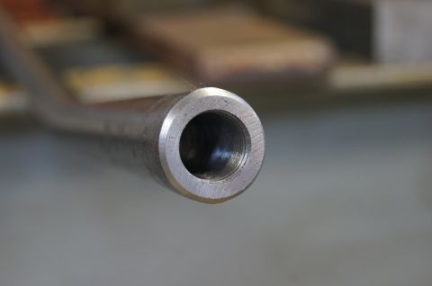 1979 Ford Bronco - A close-up shot focuses on the threaded end of a metal tube, possibly a component from a vehicle.