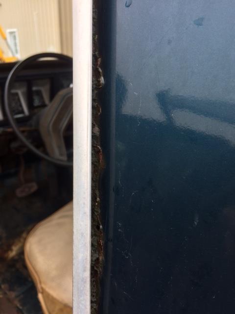 1979 Ford F-150 - Close-up of a rusty door frame inside a 1979 Ford F-150, showing interior elements.