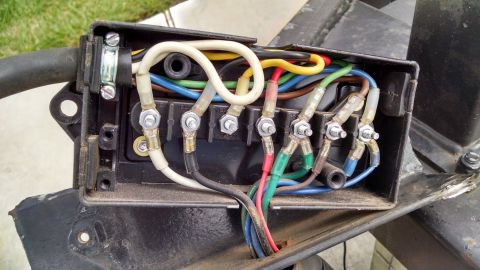2016 Ford F-250 - Close-up view of a wiring harness junction box, showing various colored wires connected to screw terminals.