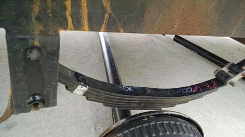 2016 Ford F-250 - A close-up view of a vehicle's leaf spring assembly, showing handwritten markings and a SuperMotors logo.