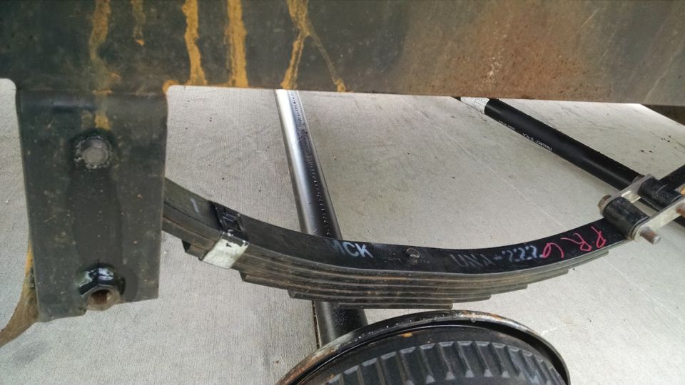 Leaf spring assembly with handwritten markings 'CK' and 'UN1-2223 PR GR'