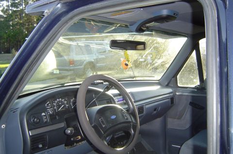 1993 Ford Bronco - Interior of a 1993 Ford Bronco, the dashboard, steering wheel, and a glimpse of another vehicle through the windshield.