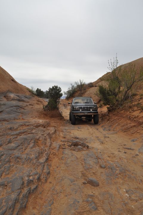 1991 Ford Bronco - This 1991 Ford Bronco navigates a challenging off-road path through a desert landscape.