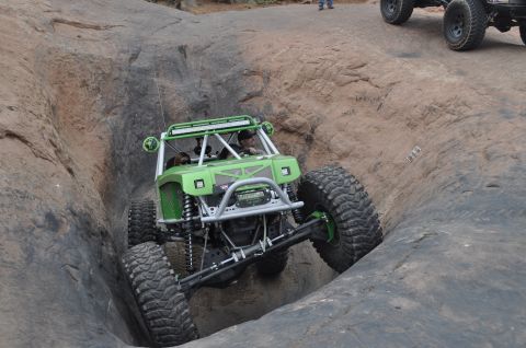 1991 Ford Bronco - This custom off-road buggy is tackling a challenging rock climb, demonstrating its extreme suspension and tire capabilities.