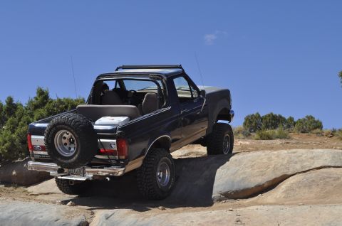1991 Ford Bronco - This 1991 Ford Bronco is navigating a rocky trail with a clear blue sky overhead.