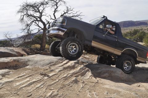 1991 Ford Bronco - This lifted Ford Bronco navigates a rocky desert terrain, its off-road capabilities.