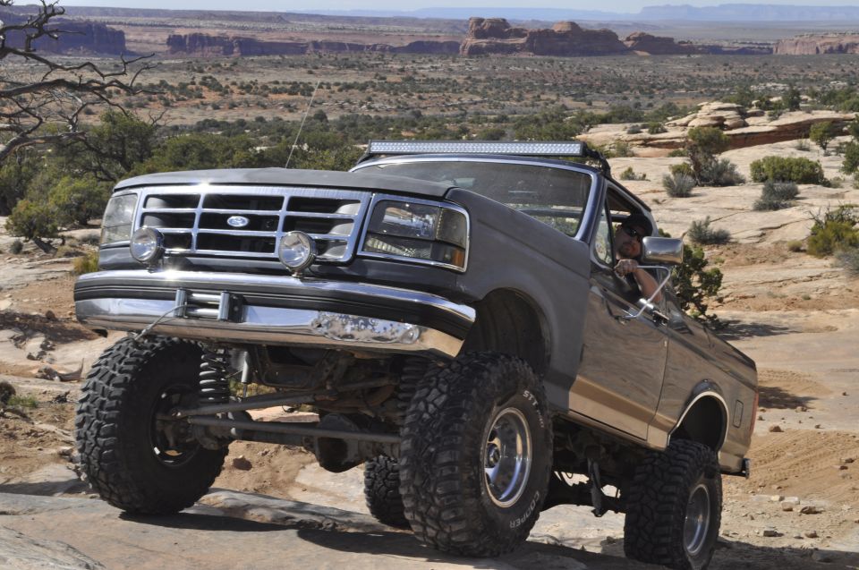 Gray lifted 1992 Ford Bronco on rocky terrain
