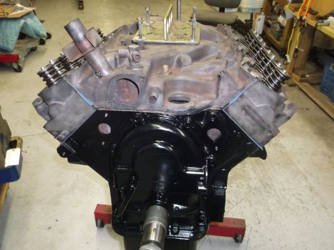 1964 Ford Galaxie - A V8 engine block is shown, partially assembled, in a workshop setting.