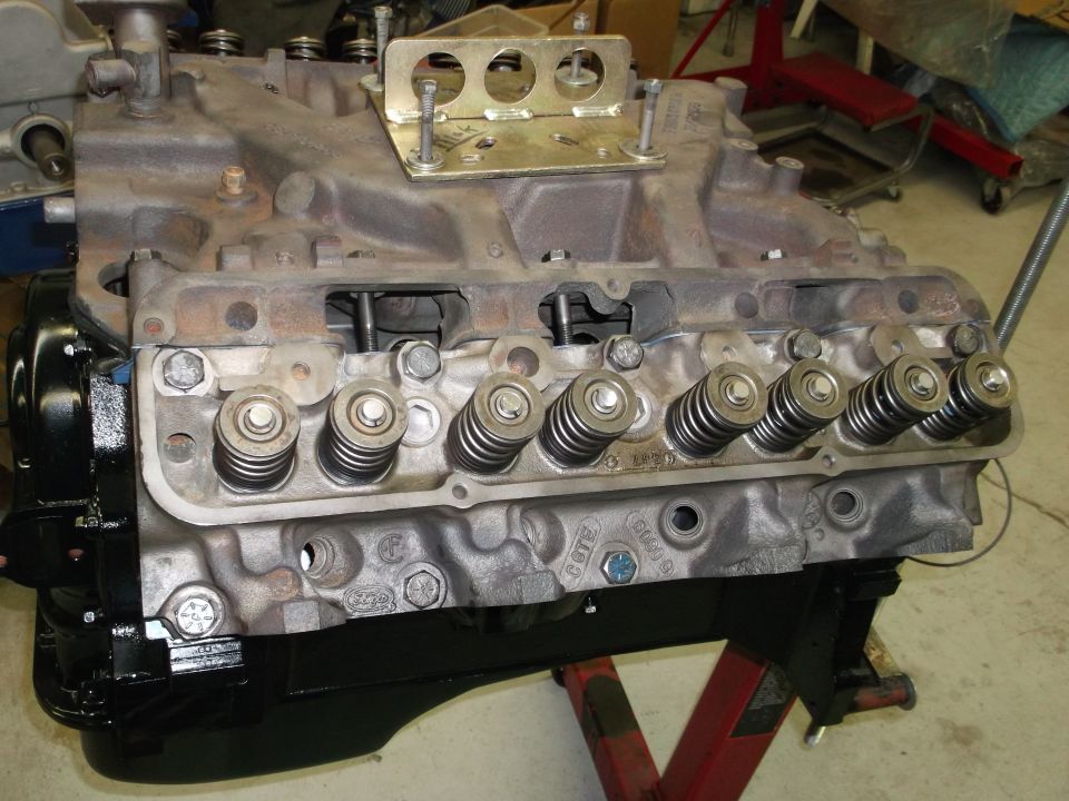 V8 engine block with valve springs and intake manifold, on an engine stand