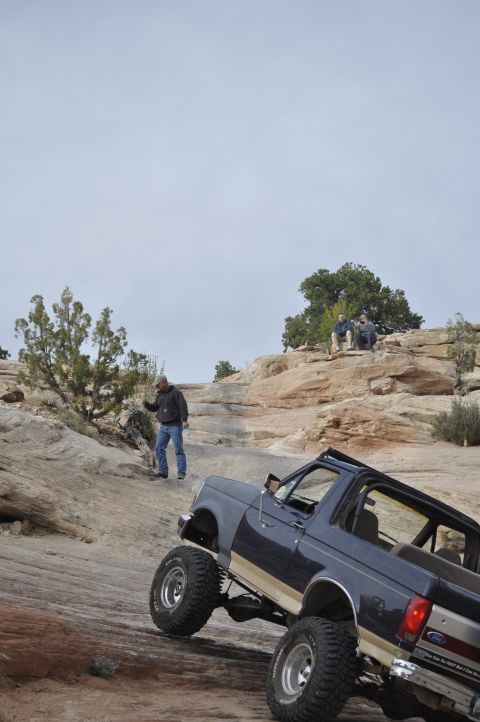 1991 Ford Bronco - This 1991 Ford Bronco navigates a steep, rocky trail in a desert landscape.