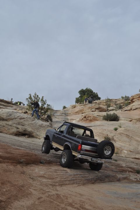 1991 Ford Bronco - This 1991 Ford Bronco is navigating a challenging off-road course in a desert landscape.