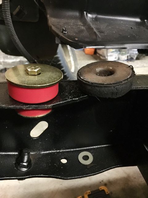 1978 Ford Bronco - Comparison of a new red polyurethane body mount bushing and an old, worn rubber bushing.