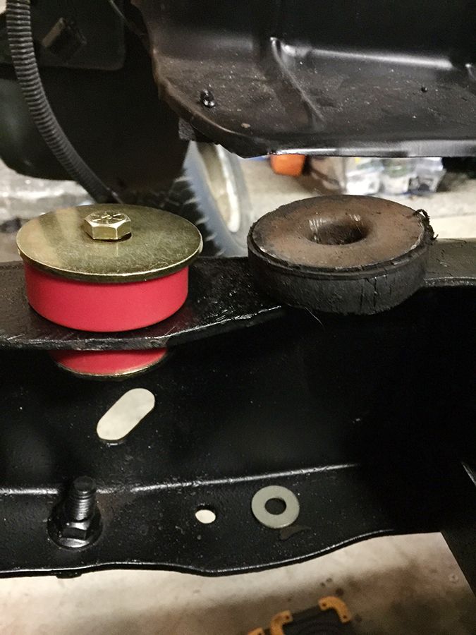 Red polyurethane body mount bushing and old rubber bushing