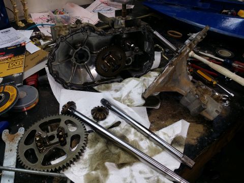 2007 Subaru Impreza - A disassembled transmission or differential sits on a workbench with various tools and parts.