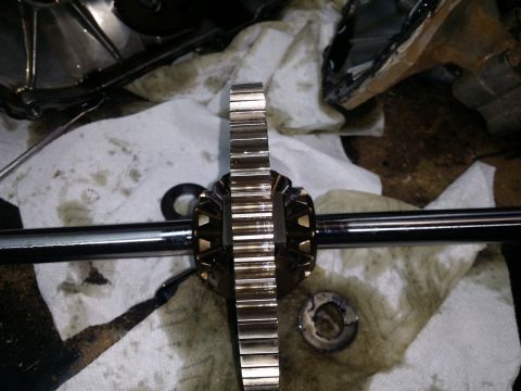 2007 Subaru Impreza - Close-up of differential gears and a metal shaft resting on paper towels, with visible oil stains.