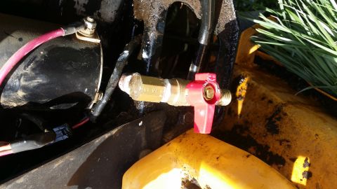 2007 Subaru Impreza - A close-up view of a red valve and brass fitting attached to yellow machinery.